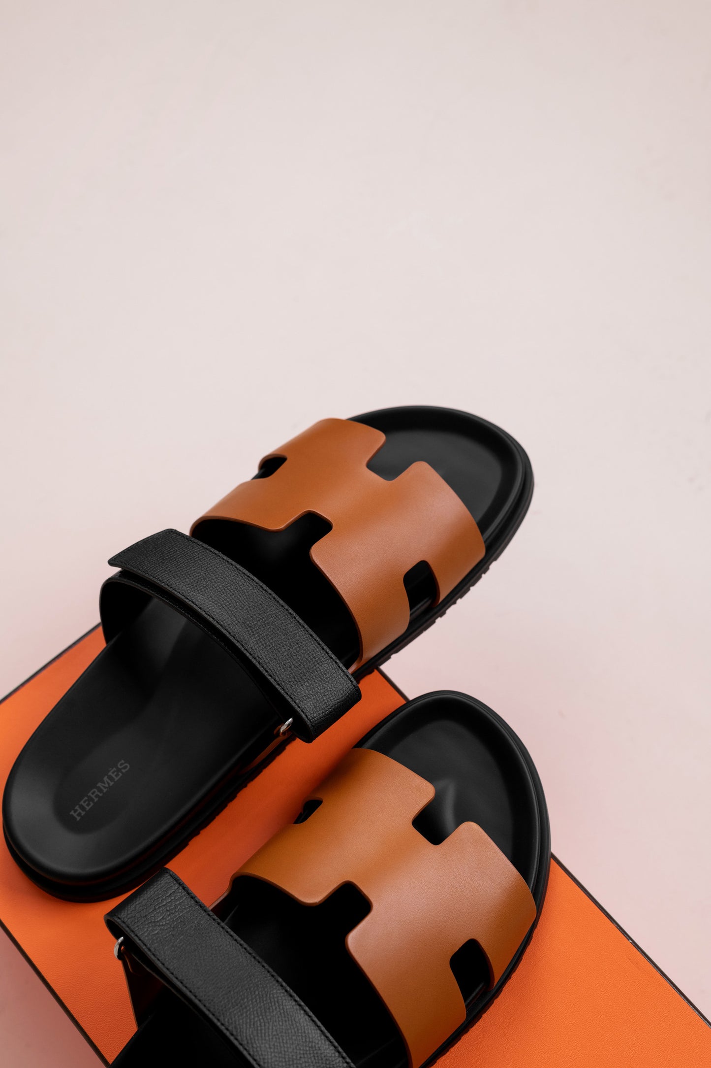 Hermès Chypre Sandals in Gold/Black
