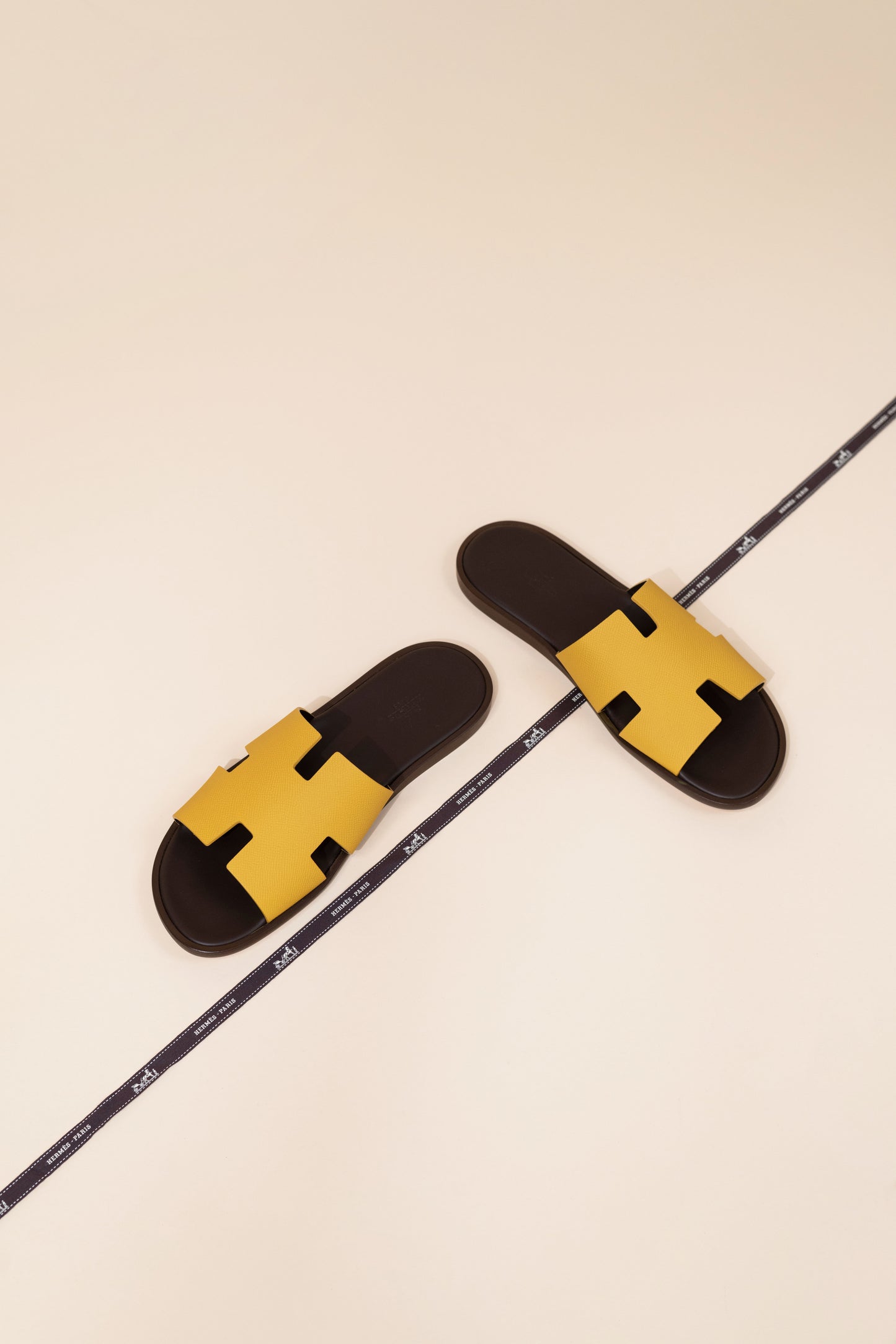 Hermès - Izmir Sandals in Jaune Ambre