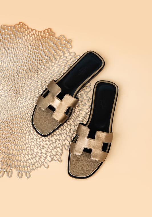 Hermès Oran Sandals in Metallic Gold