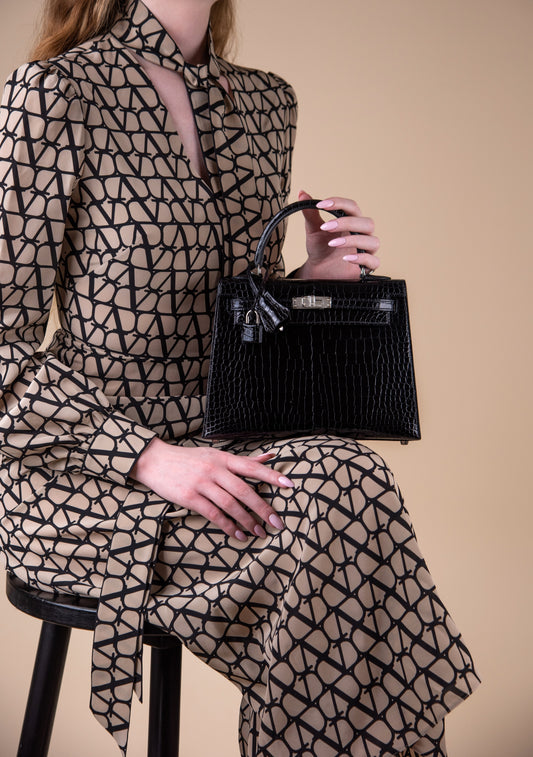 Hermès Kelly 25 Black Shiny Crocodile PHW with Valentino Crepe de Chine Logo Midi Dress