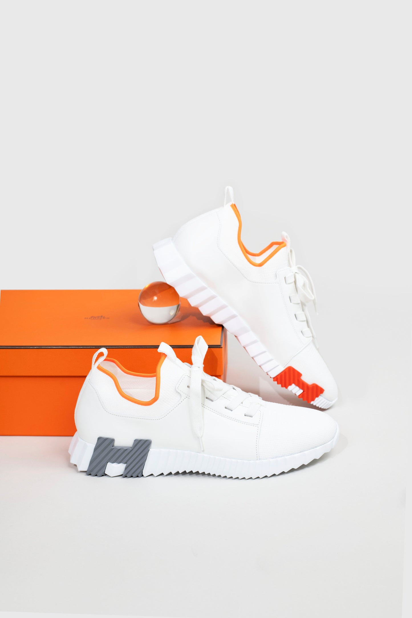 Hermès Depart Sneakers in White/Orange