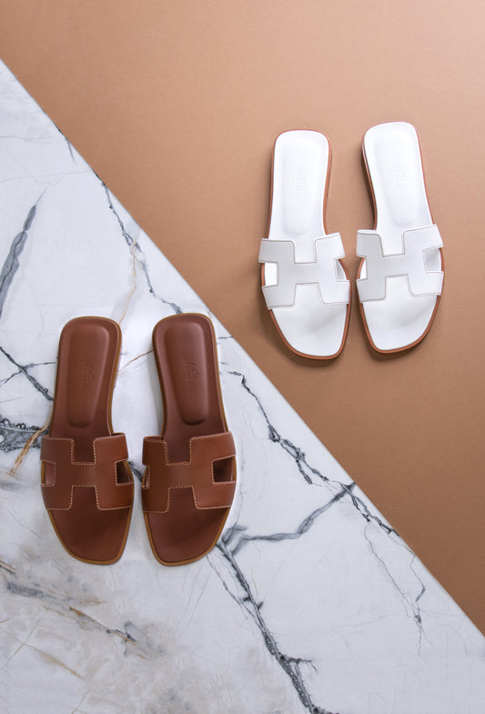 Hermès Oran Sandals in Gold & White