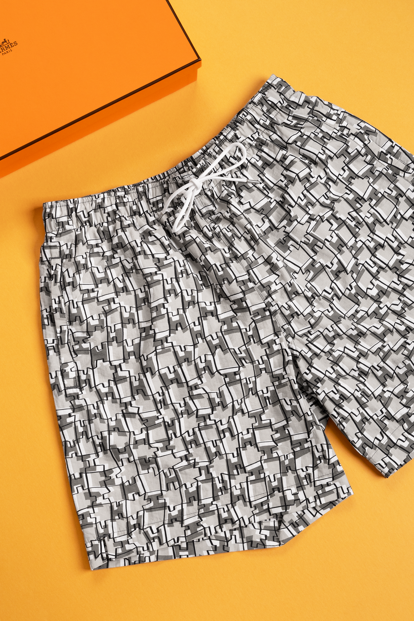 Hermès "H Cut Remix" swim trunks in Gris Éléphant